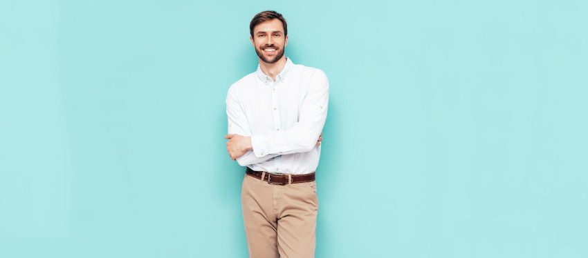 Confident man smiling with arms crossed, representing responsible EuroMillions gambling