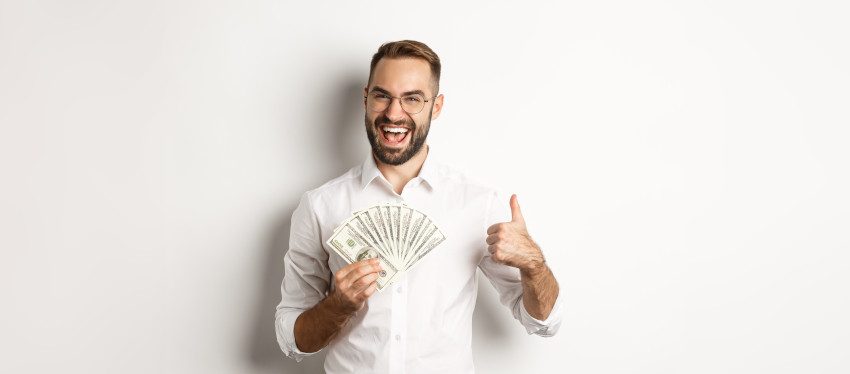 Happy man holding money, representing winning EuroMillions and smart ticket strategy